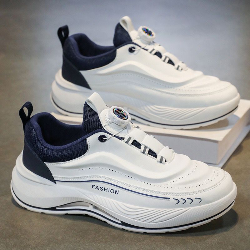 White and navy sneakers on a gray surface