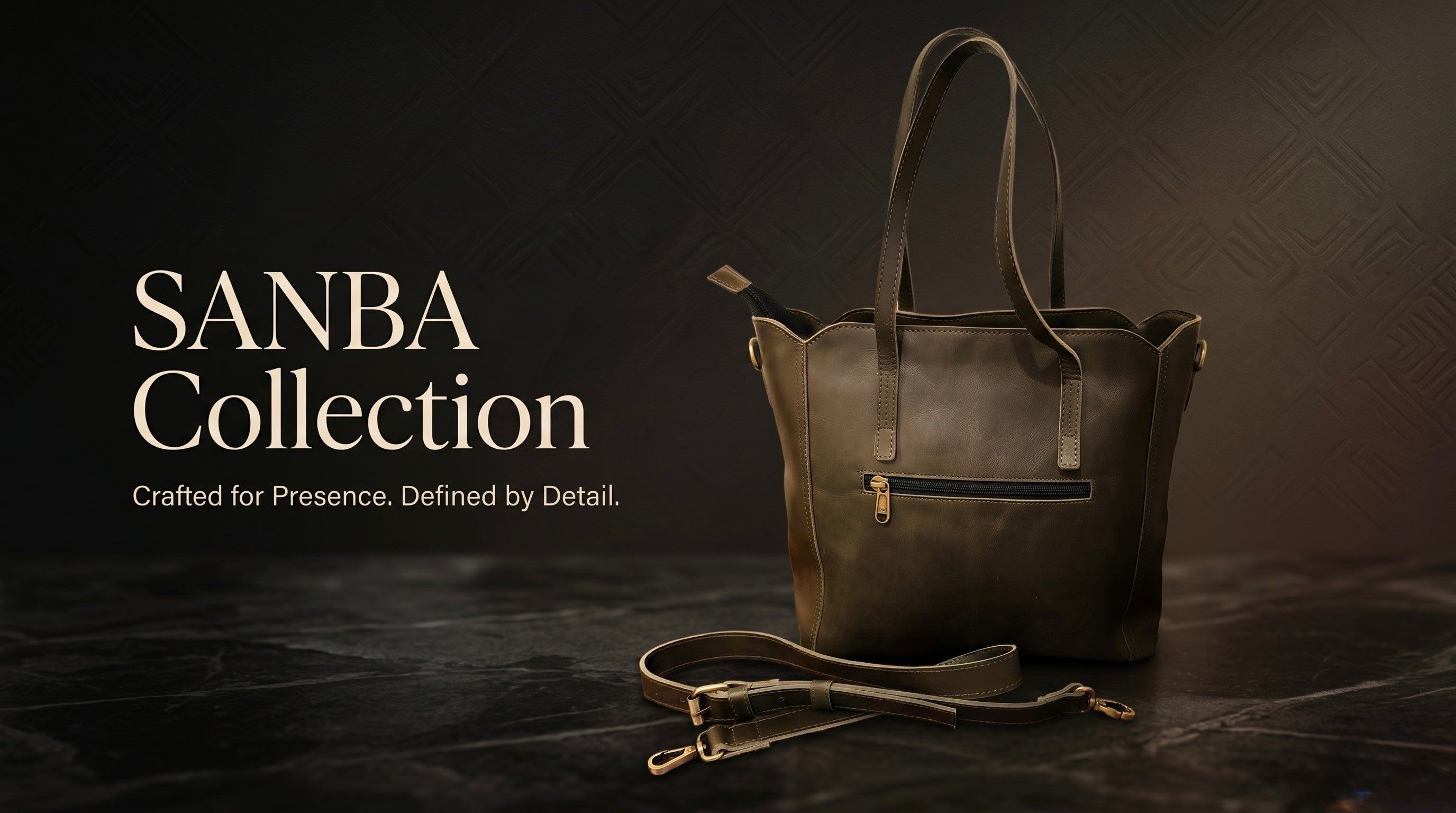 Brown leather handbag with 'SANBA Collection' text on a dark background