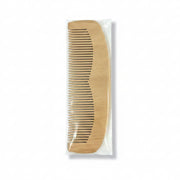 A wooden hair comb packaged in a clear plastic cover with a blue and white product label.