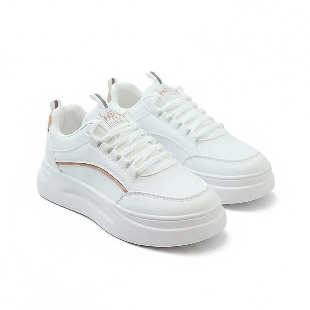 White sneakers on a gray surface with a magazine in the background
