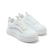 White sneakers on a gray surface with a magazine in the background