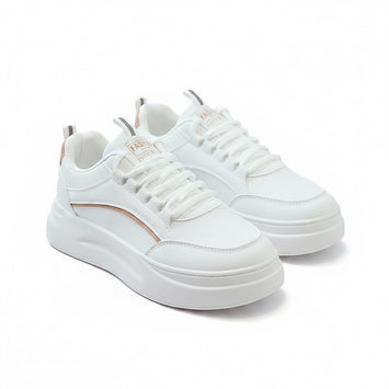 White sneakers on a gray surface with a magazine in the background