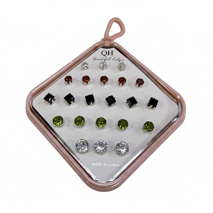 Set of earrings in a display case on a white background