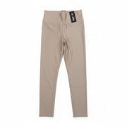 Beige leggings with a brand tag on a white background