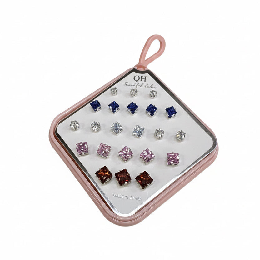 Set of earrings in a pink case on a white surface