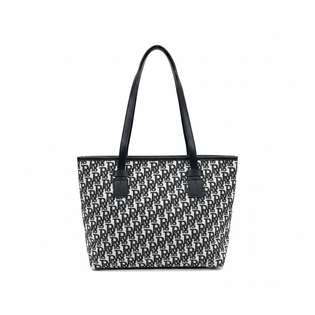 Black and white patterned bag with a handle on a shelf with various items.