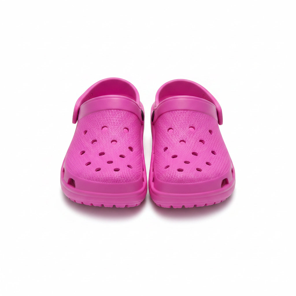 Pair of pink clogs on a white background