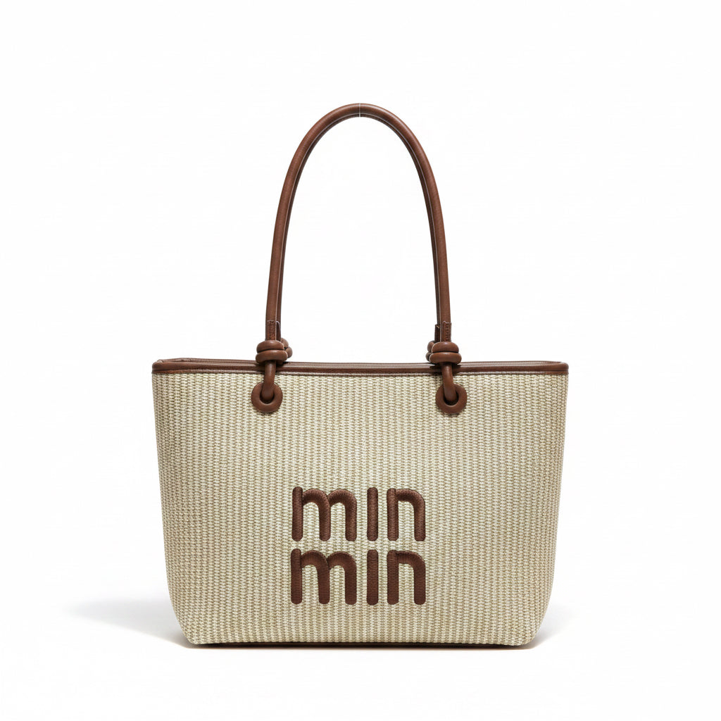 Woven handbag with brown handles and 'min min' branding on a light background