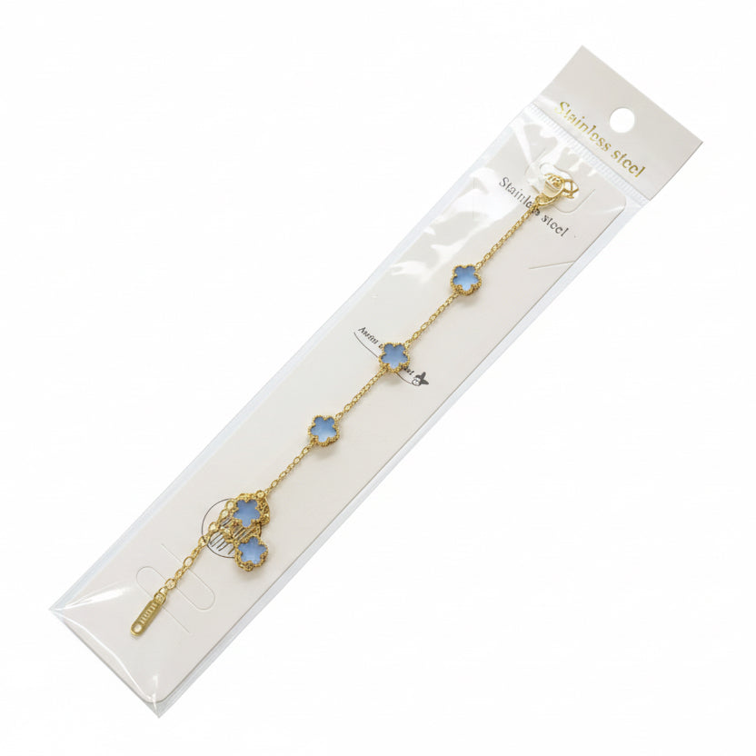 Gold chain earrings with blue heart charms in packaging on a white background