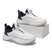 White and navy sneakers on a gray surface