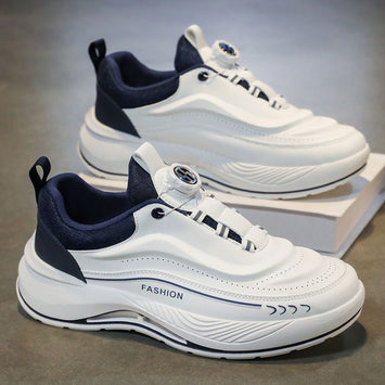 White and navy sneakers on a gray surface