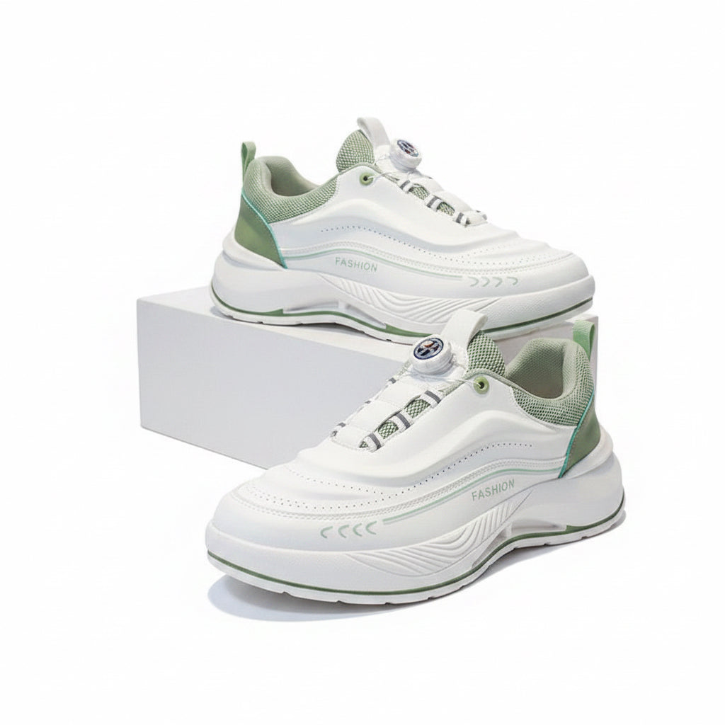 White and green sneakers on a gray surface