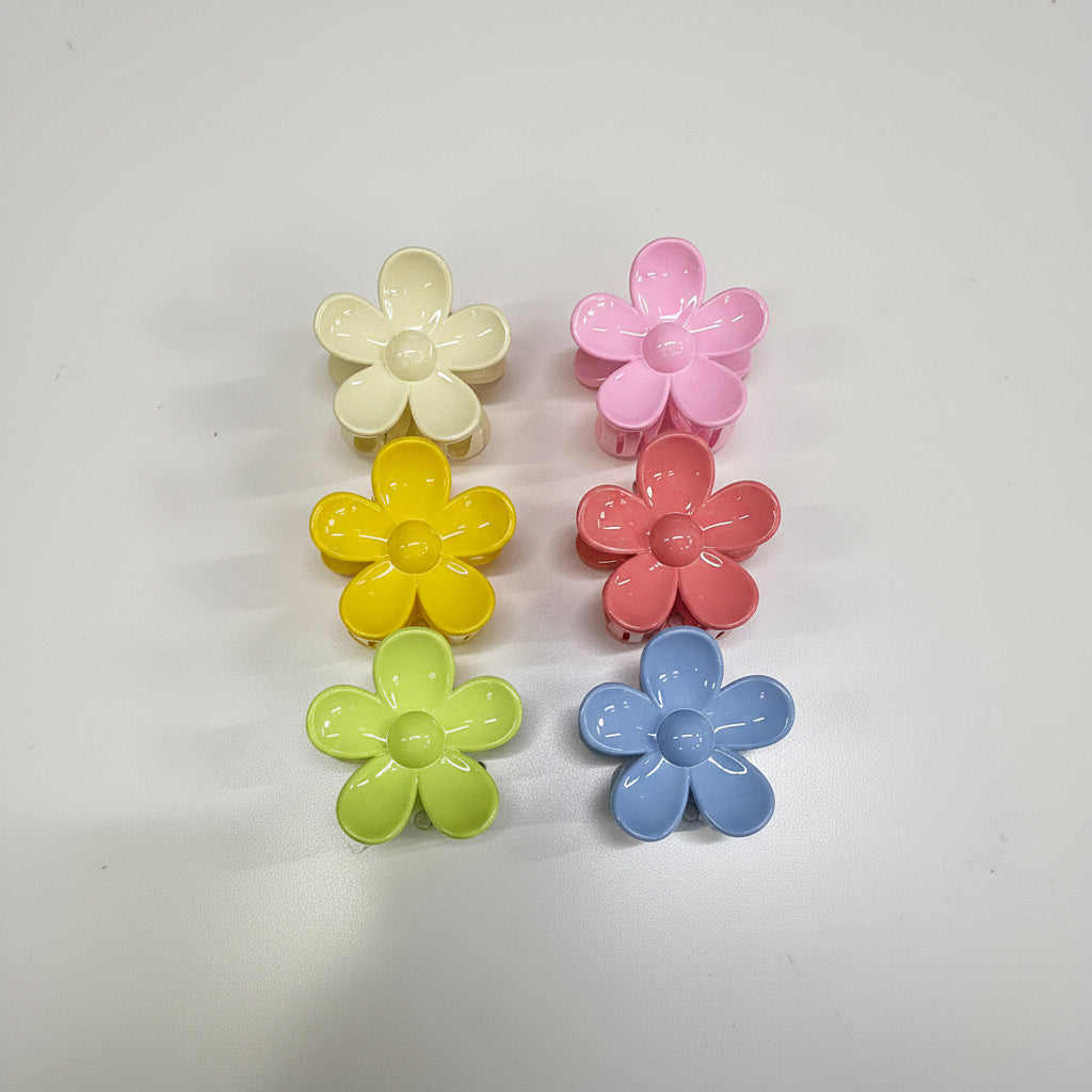 Set of colorful flower-shaped hair clips on a card with 'Made in China' text.