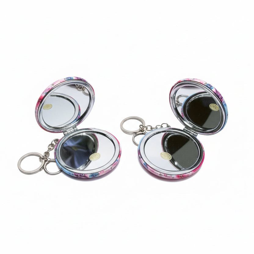 Two compact mirrors with floral designs on a white background
