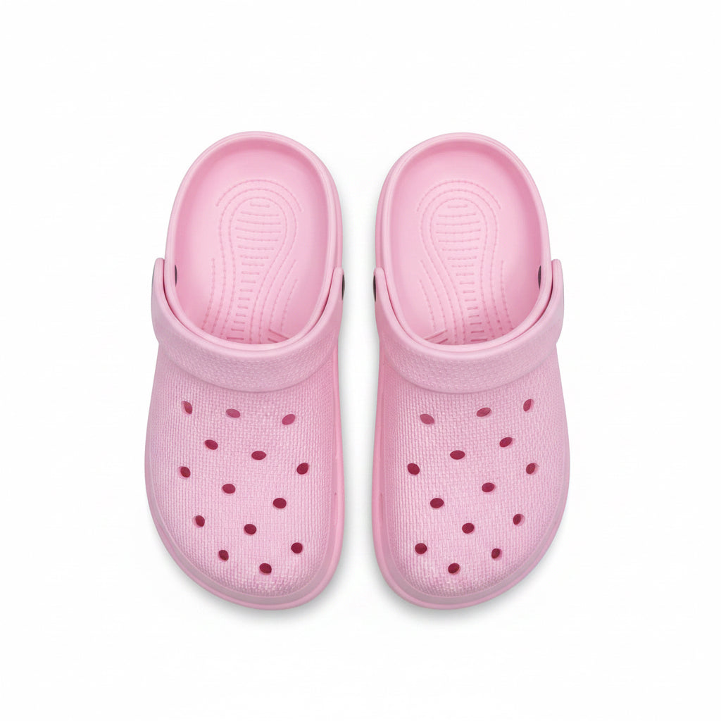 Pair of pink clogs on a white background