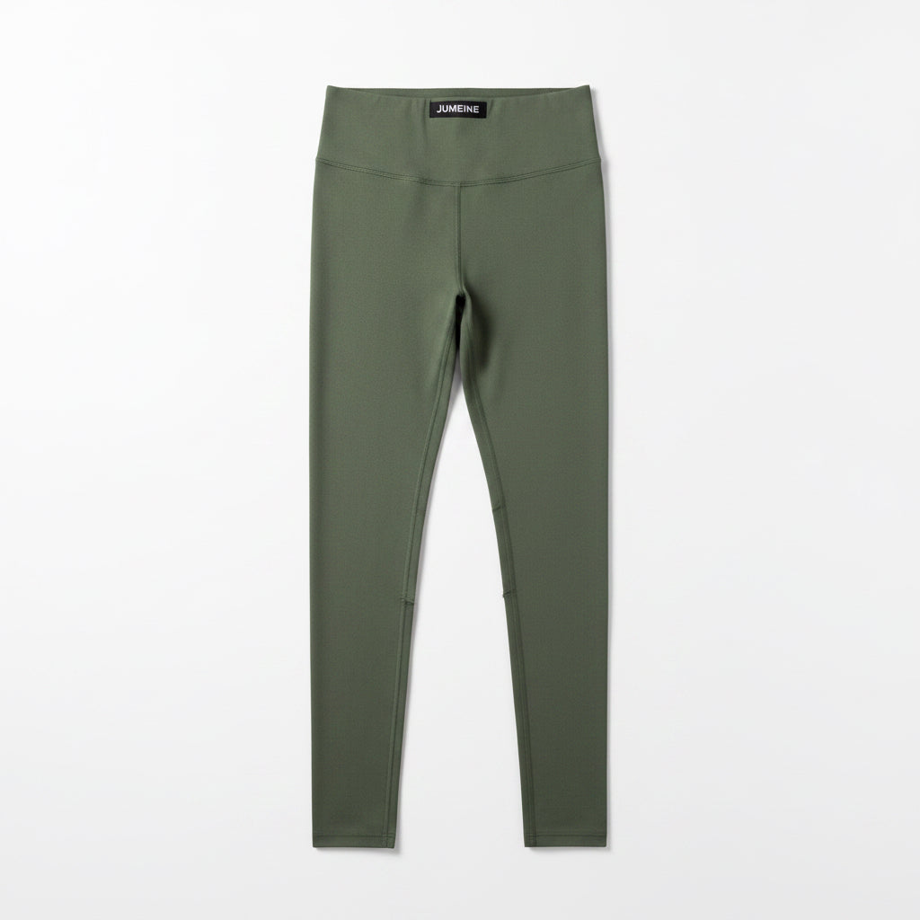 Green leggings with a brand label on a white background