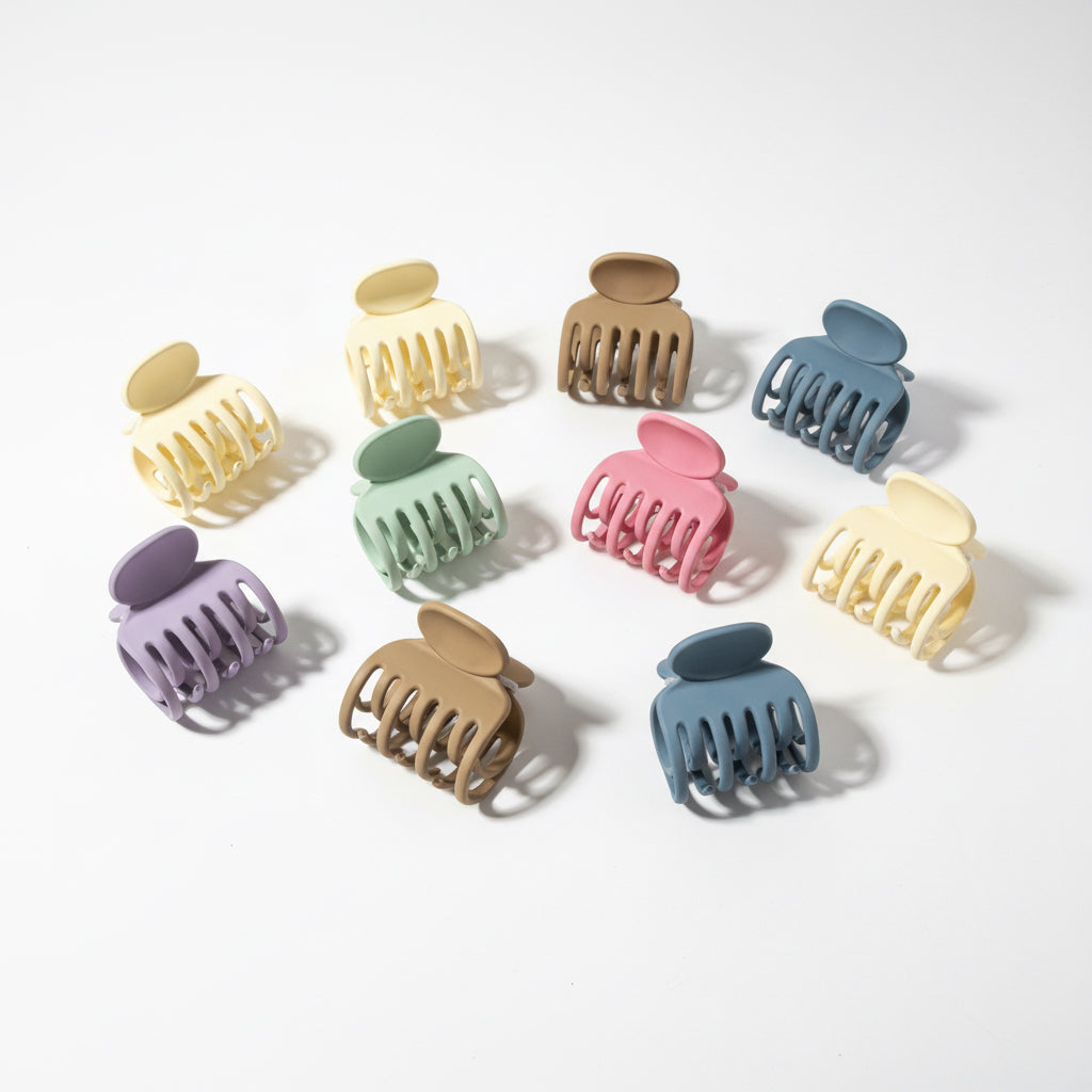 Set of colorful hair clamps on a white background