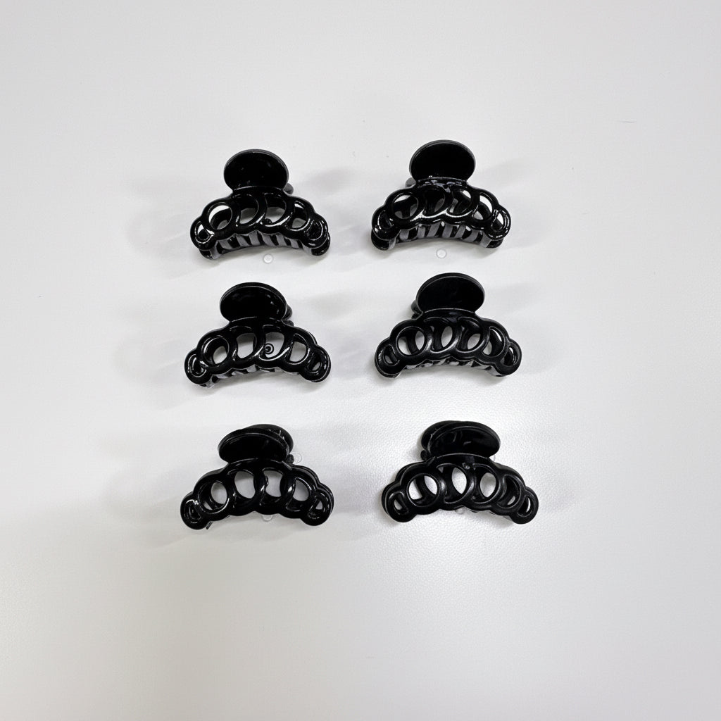 Set of black hair clips on a green and black packaging with 'Made in China' text.