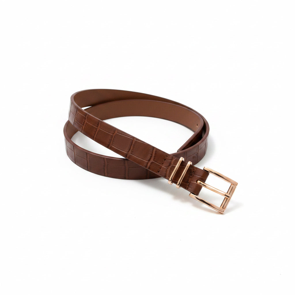 Brown belt with a gold buckle on a textured white background