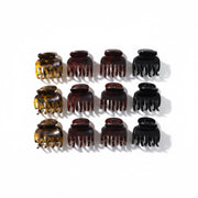 Set of twelve hair clamps in various colors on a white background