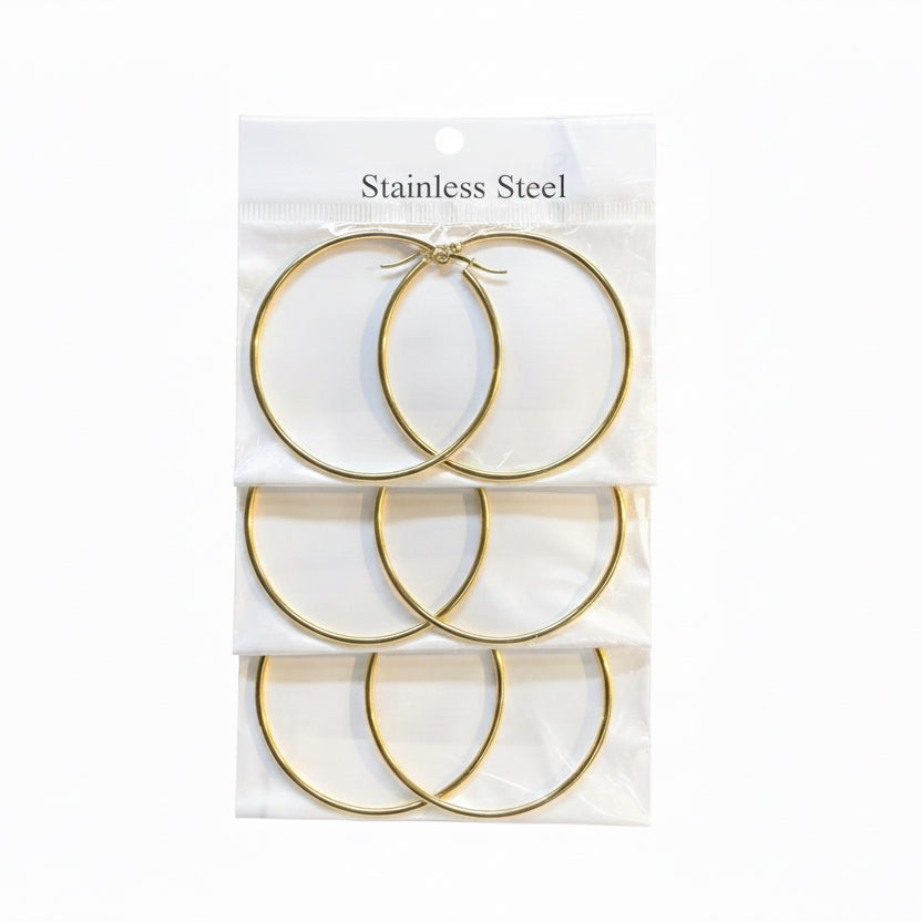 Set of gold hoop earrings in packaging with 'Stainless Steel' text on a white background