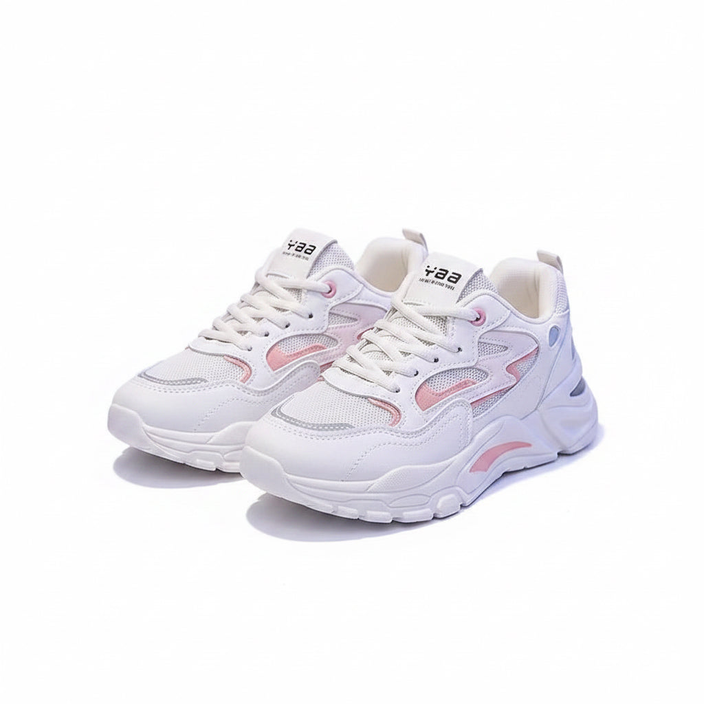 White sneakers with pink and blue accents on a dark surface