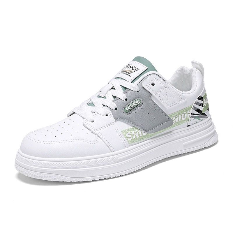 White sneaker with gray and green accents on a white background