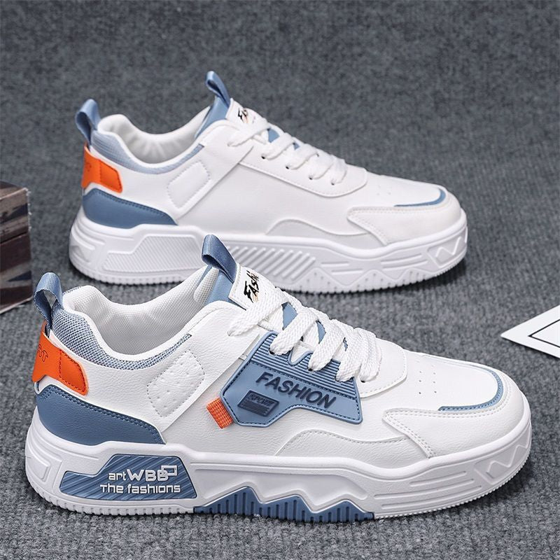 White sneakers with blue and orange accents on a gray surface