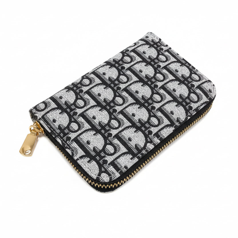 Black and white patterned pouch with a gold zipper on a white background
