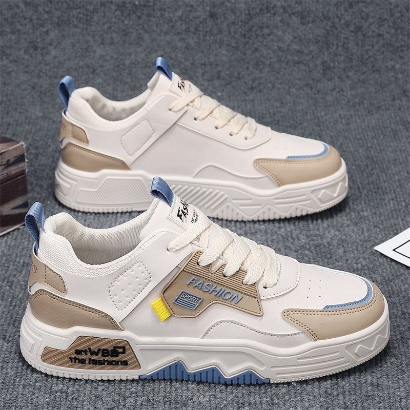 White and beige sneakers with blue accents on a gray background