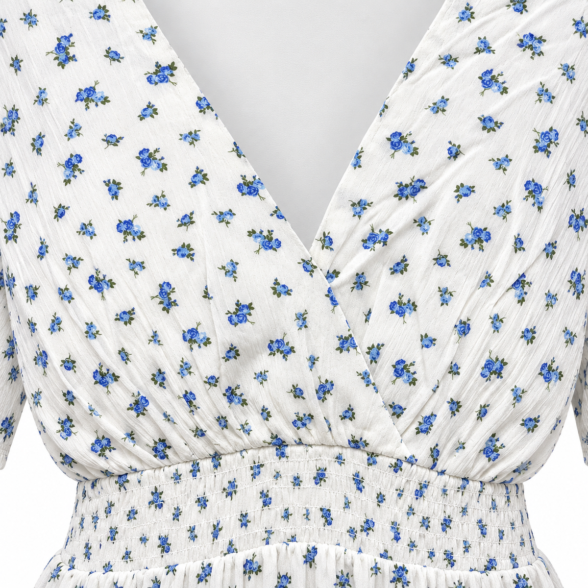 Close-up of AMISU floral dress showing blue flower print, wrap-style V-neckline and smocked elasticated waist.