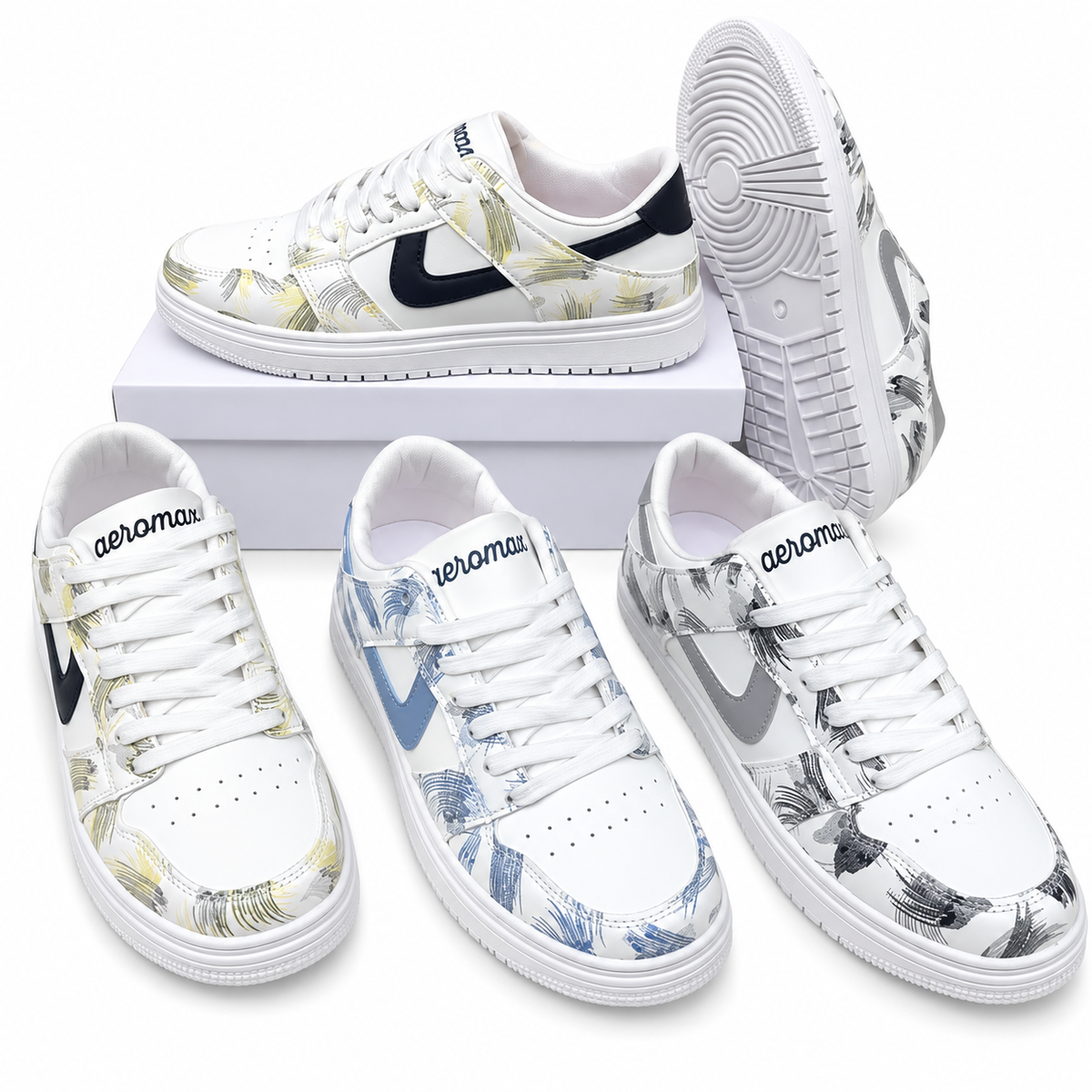 Four low-top Nike sneakers with a white base and tropical leaf print in various colorways, arranged on a white background with one shoe on a white box.