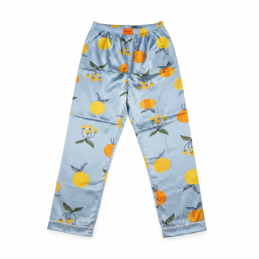 Light blue pajama pants with orange and cherry pattern on a white background