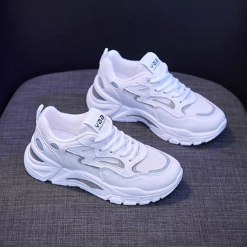 White sneakers with brand logo on a dark background
