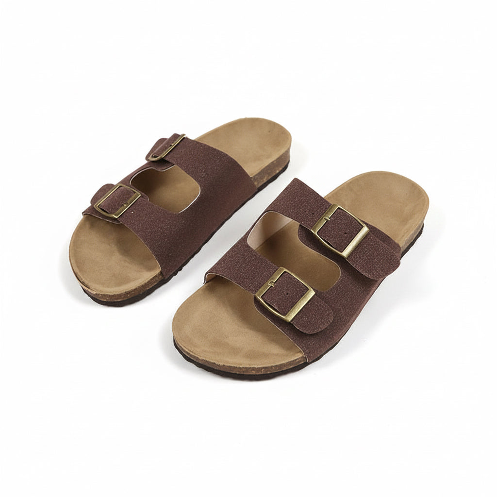 Pair of brown sandals with buckles on a beige background