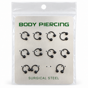 Black horseshoe piercing rings displayed on surgical steel body piercing packaging
