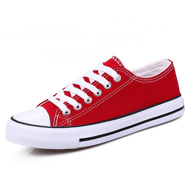 Red sneaker with white laces on a white background