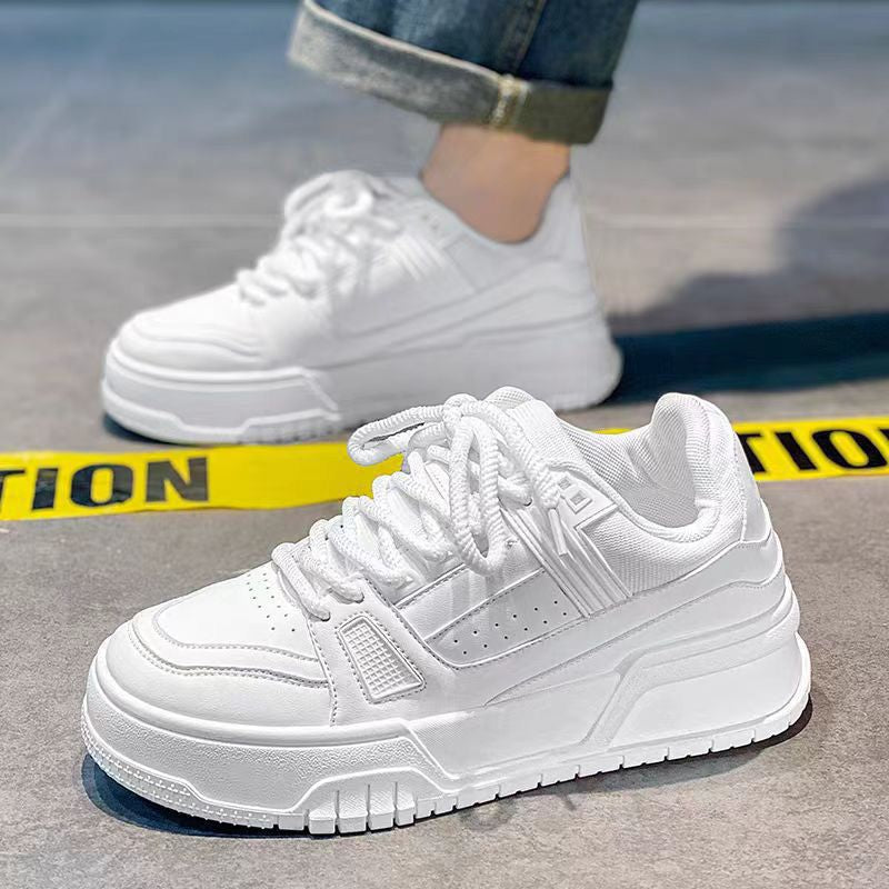 White sneakers on a concrete surface with a yellow caution tape in the background