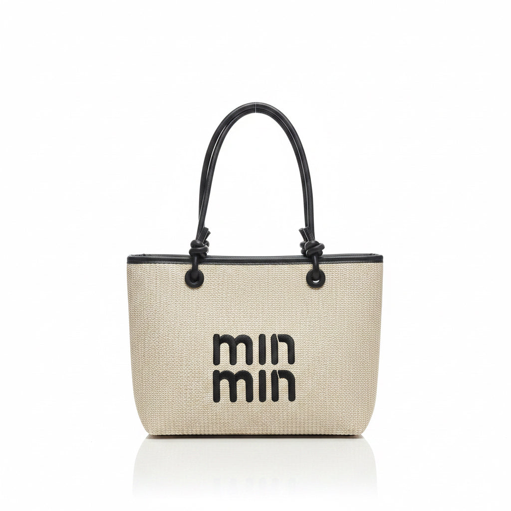 Woven handbag with black handles and 'min min' branding on a light background