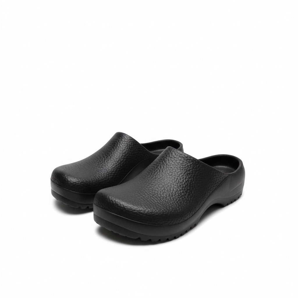 Pair of black clogs on a white background