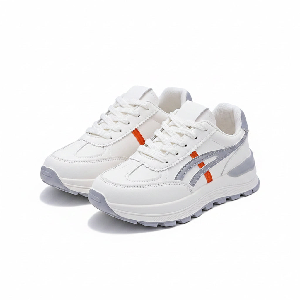 White sneakers with gray and orange accents on a white surface.