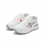 White sneakers with gray and orange accents on a white surface.