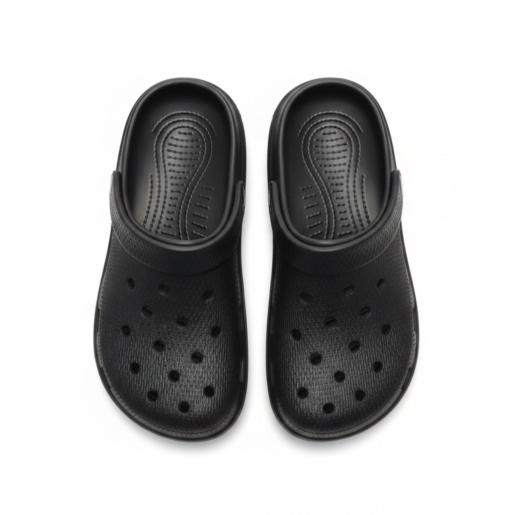 Pair of black clogs on a white background