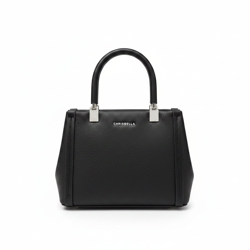 Black handbag held by a person with a blurred store background