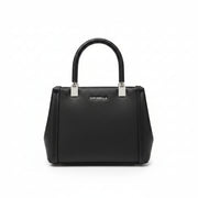 Black handbag held by a person with a blurred store background