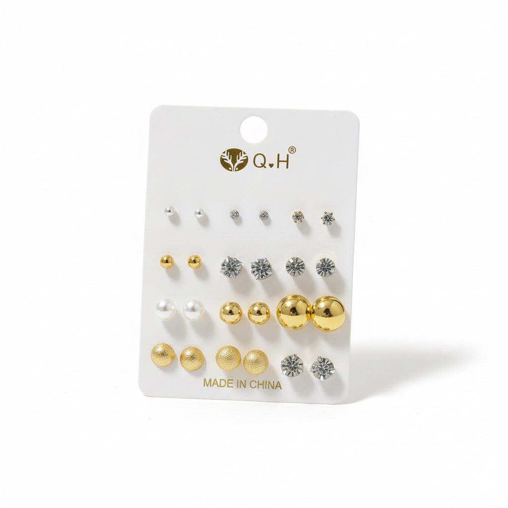 Set of earrings on a Q&H branded card with gold and silver designs.