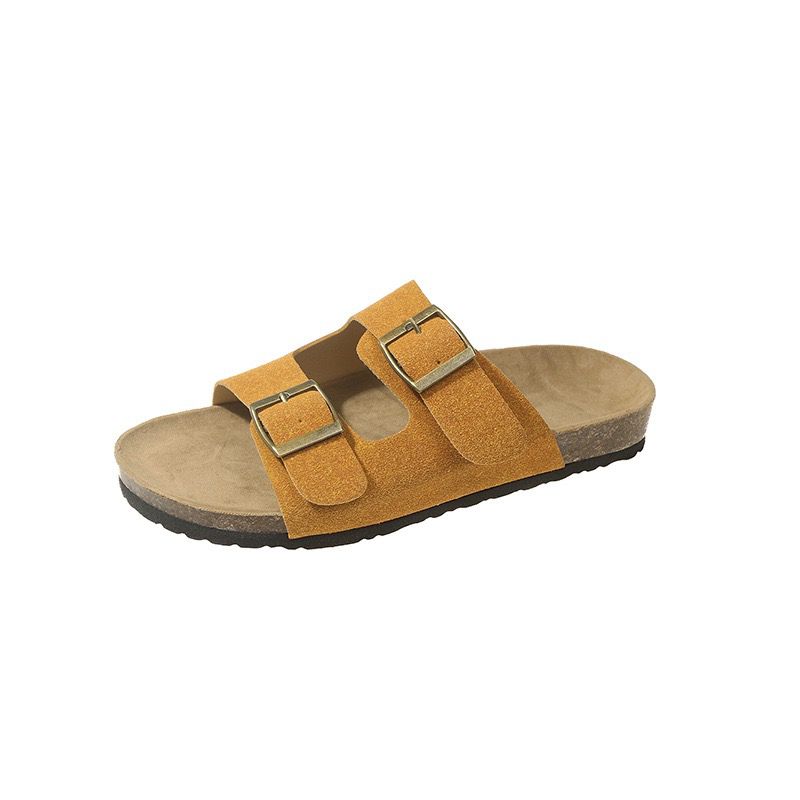 Yellow sandal with two buckles on a white background