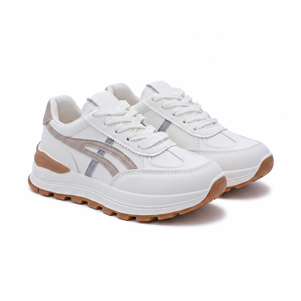 White sneakers with brown soles on a white surface