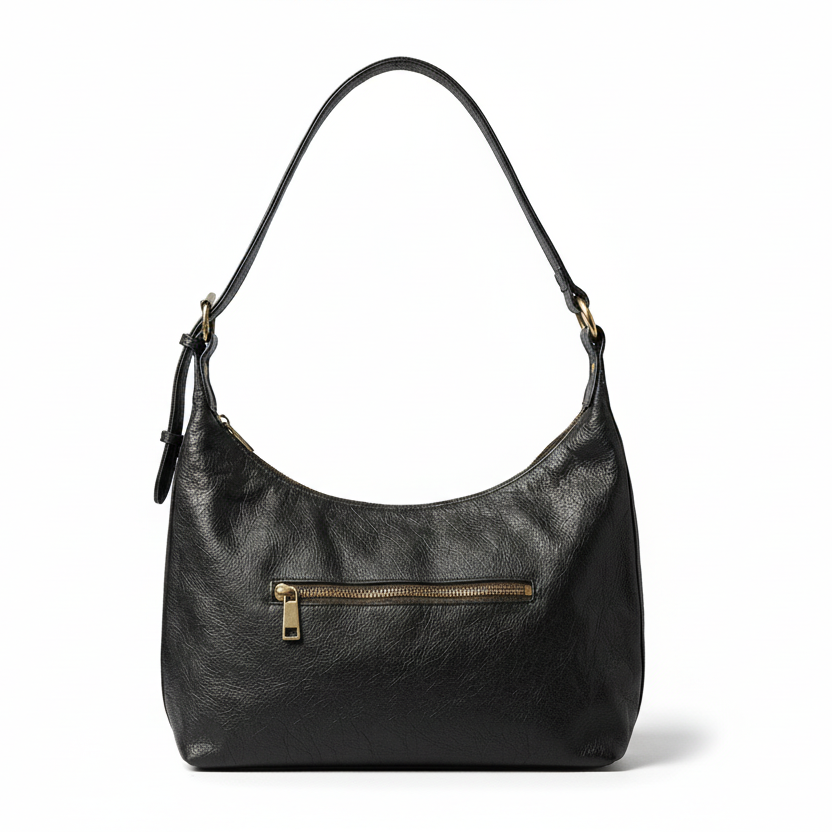Black leather handbag with a gold zipper on a gray background