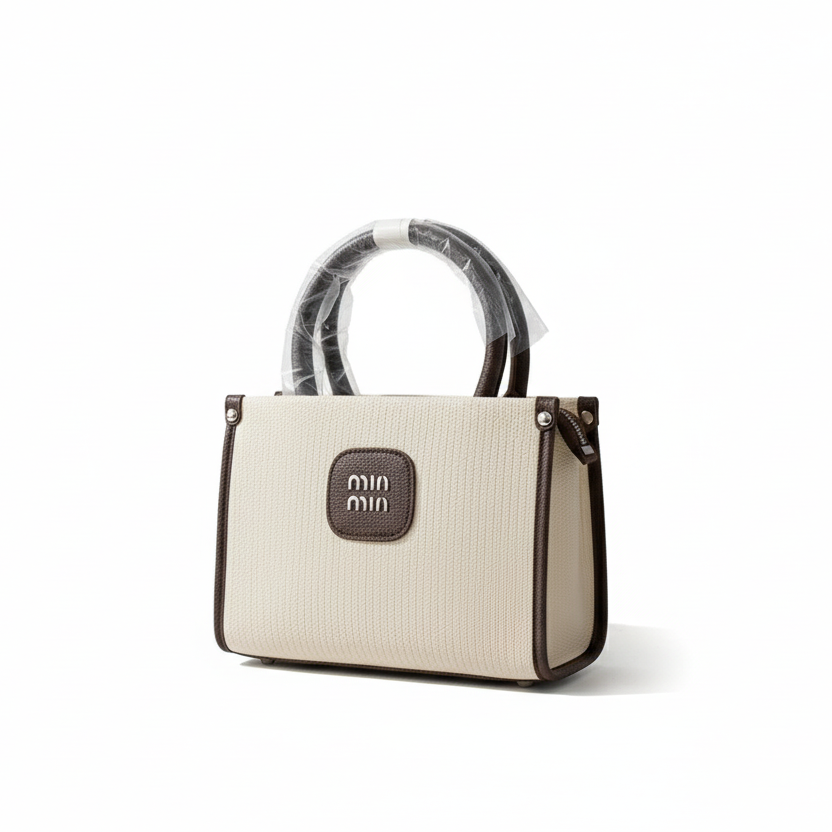 Beige handbag with a clear plastic cover on a white background